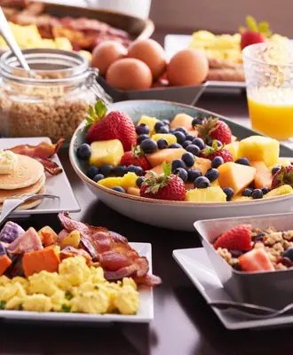 a table topped with plates of breakfast foods and eggs at Hyatt Place Kelowna in Kelowna