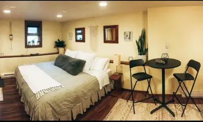 a bedroom with a bed and a table and chairs at Wildflower Suite in Whistler