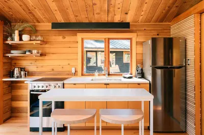 a kitchen with a sink and a refrigerator at Bodega Ridge & Cove Cabins in Fernwood