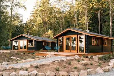 a log cabin in the middle of a forest at Bodega Ridge & Cove Cabins in Fernwood
