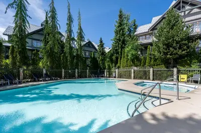a large swimming pool in a yard with a fence at Stoney Creek Northstar by Whistler Premier in Whistler