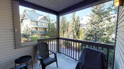 a screened in porch with two chairs and two windows at Stoney Creek Northstar by Whistler Premier in Whistler