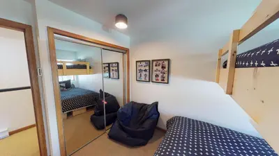 a bedroom with a mirror and a bed and a mirror at Stoney Creek Northstar by Whistler Premier in Whistler