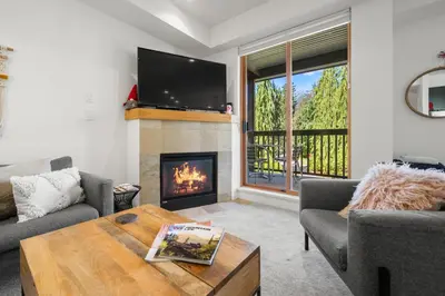 a living room with a fireplace and a tv at Stoney Creek Northstar by Whistler Premier in Whistler