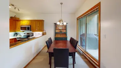 a kitchen with a table and chairs in a room at Painted Cliff by Whistler Premier in Whistler