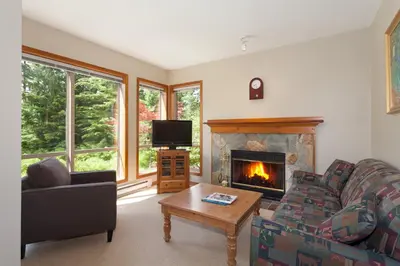 a living room with a couch and a fireplace at Painted Cliff by Whistler Premier in Whistler