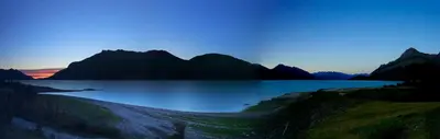 a view of a lake with mountains in the background at David Thompson Resort in Cline River