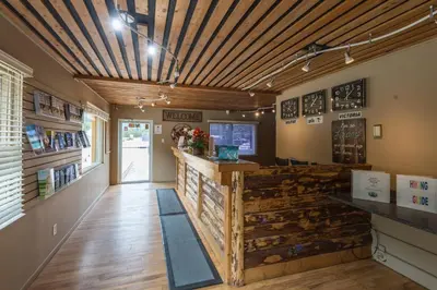 a restaurant with a wooden ceiling and a counter at David Thompson Resort in Cline River