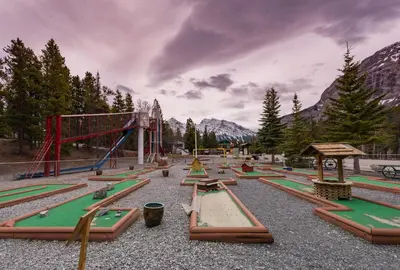 a playground with a bunch of play equipment at David Thompson Resort in Cline River