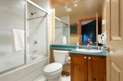 a bathroom with a toilet and a sink and a shower at Symphony by Whistler Premier in Whistler