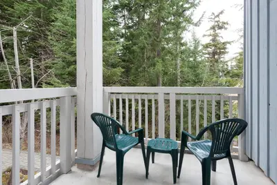 two chairs and a table on a porch at Treeline Townhome by Whistler Premier in Whistler