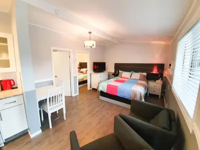 a bedroom with a bed and a desk and a chair at The Orchard at Oliver in Oliver