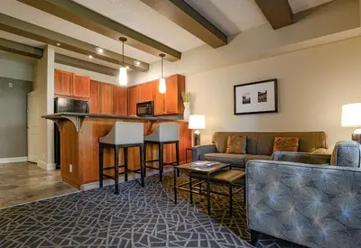 a living room with a couch and a bar at Fairways Hotel on the Mountain in Victoria