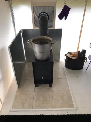 a pot on top of a stand in a kitchen at Vines and Puppies Glamping Hideaway in Jade City
