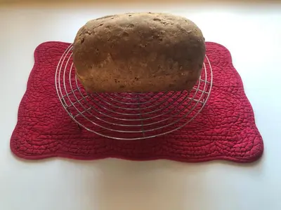 a loaf of bread sitting on a plate on a table at Vines and Puppies Glamping Hideaway in Jade City