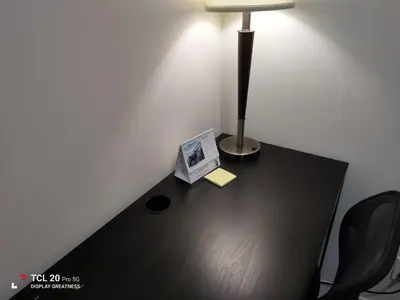 a desk with a lamp and a picture on it at Sweet House B&B in Victoria