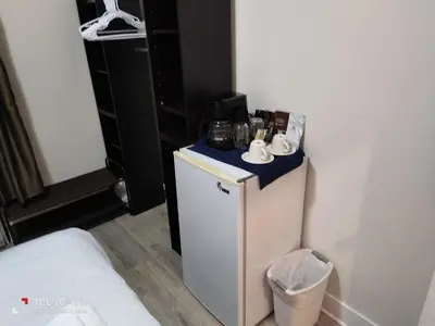 a small refrigerator in the corner of a room at Sweet House B&B in Victoria