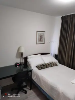 a bedroom with a bed and a desk with a bed at Sweet House B&B in Victoria