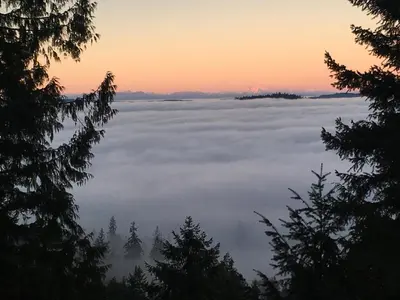 a view of a sea of clouds at sunset at The Sanctuary Retreat Salt Spring Island in Salt Spring Island