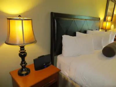 a bedroom with a bed and a lamp on a night stand at Village Creek Country Inn in Westerose