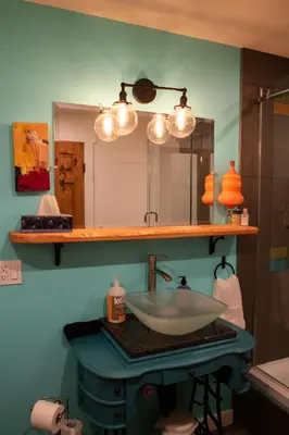 a bathroom with a sink and a mirror at eARTh studios GallerySuite in Nelson