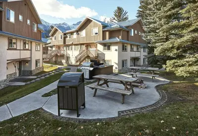 a park with a picnic table and a trash can at Mountain Gate - Pet Friendly 2BR w Mountain Views and open hot tub in Canmore