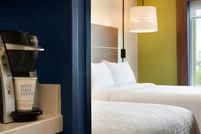 a hotel room with two beds and a coffee maker at Holiday Inn Express & Suites - Calgary Airport Trail NE by IHG in Calgary