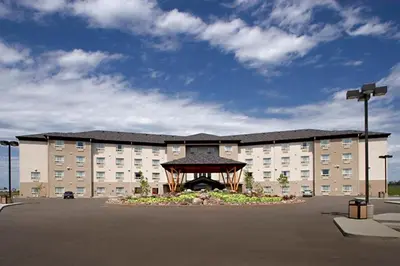 a large building with a gazebo in a parking lot at Gold Eagle Lodge in North Battleford
