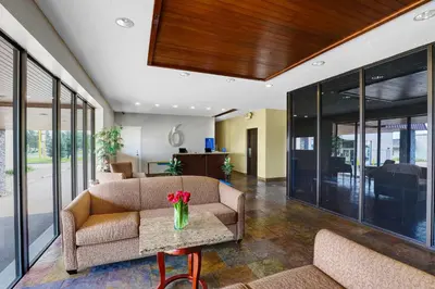 a lobby with a couch and a table at Motel 6 Brooks AB in Brooks