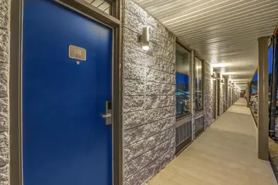 a blue door in the hallway of a building at Motel 6 Brooks AB in Brooks