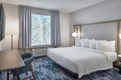 a hotel room with a large bed and a window at Fairfield Inn & Suites by Marriott Penticton in Penticton