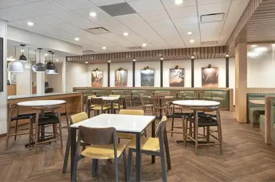 a rendering of a restaurant with tables and chairs at Fairfield Inn & Suites by Marriott Penticton in Penticton