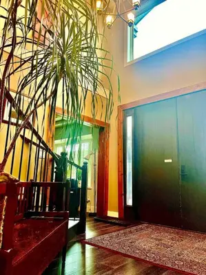 a hallway with a door and a potted plant at Corkscrew Willow Estate in Vancouver