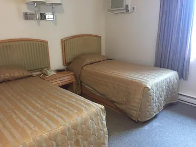 a hotel room with two beds in a room at Hotel Deoro in Lillooet