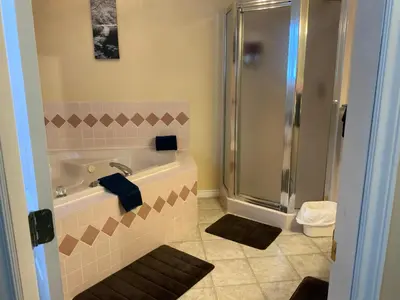 a bathroom with a bath tub and a shower at Monte Carlo Motel in Barrière