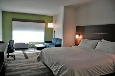 a hotel room with a bed and a desk and a chair at Holiday Inn Express & Suites - Edmonton SW – Windermere by IHG in Edmonton