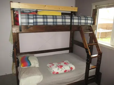 a bunk bed with a ladder and a pillow on a bunk bed at Nice Bunk Bed in Whitehorse