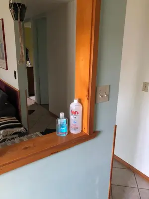a mirror with two bottles sitting on a shelf at Nice Bunk Bed in Whitehorse