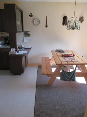 a dining room with a wooden table and a bench at Nice Bunk Bed in Whitehorse