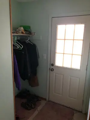 a room with a door and a closet with shoes at Nice Bunk Bed in Whitehorse