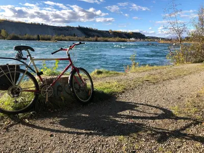a bike parked on the side of a river at Nice Bunk Bed in Whitehorse