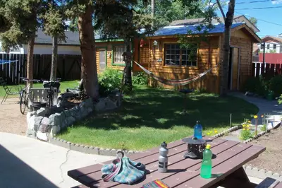a picnic table in front of a log cabin at Nice Bunk Bed in Whitehorse