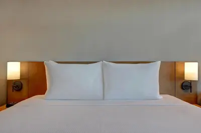 two white pillows sitting on top of a bed at Hyatt Place Prince George in Prince George