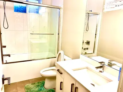 a bathroom with a shower and a toilet and sink at Deluxe House in Surrey