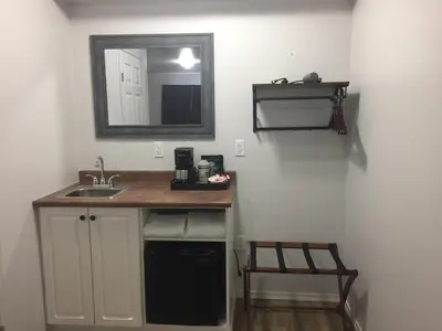 a bathroom with a sink and a mirror on the wall at Humpback Inn in Port McNeill