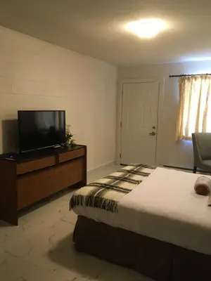 a bedroom with a bed and a flat screen tv at Christina Lake Motel and RV Park in Christina Lake