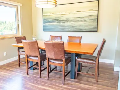 a dining room with a table and chairs at The Moorage in Ucluelet