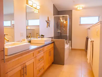 a bathroom with two sinks and a shower at The Moorage in Ucluelet