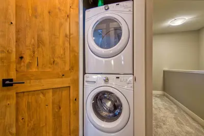 a washer and dryer in a room with a door at Echo Landing#02 By Bear Country in Sun Peaks