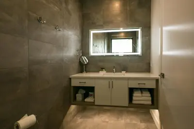 a bathroom with a sink and a mirror at The Inn at Therapy Vineyards in Naramata